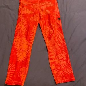 Project Rock Under Armour Red and Orange Leggings with side pockets.
